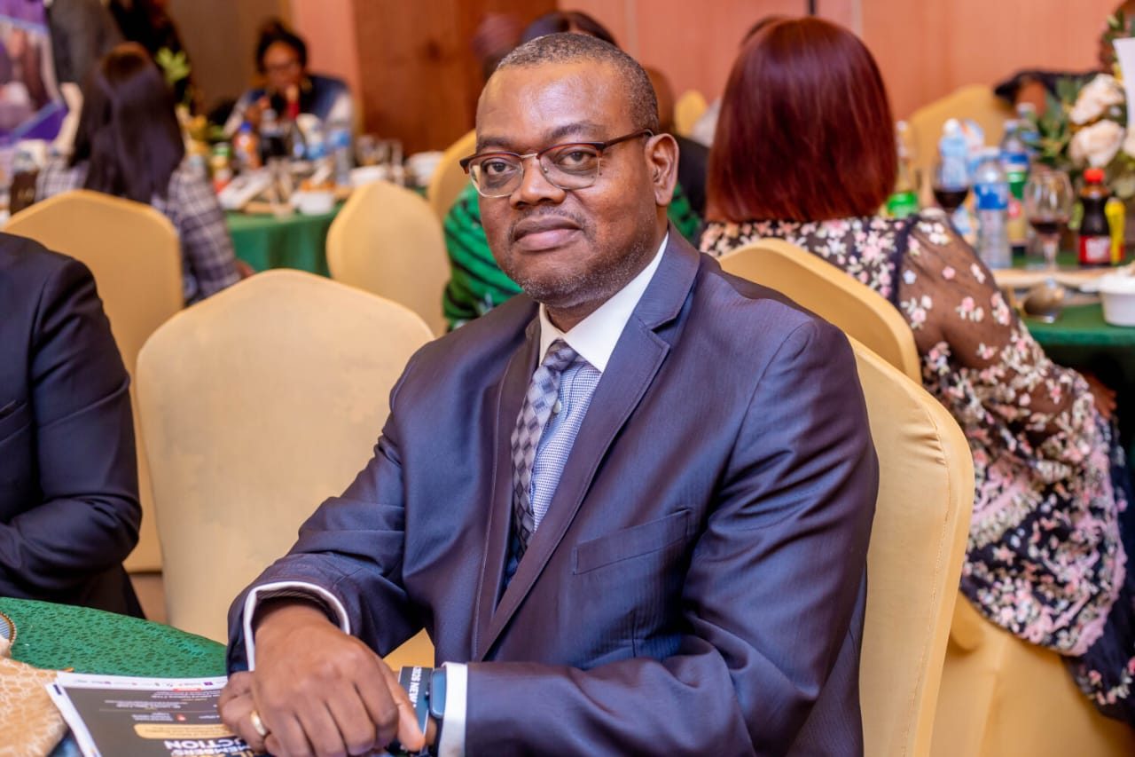 Amos Ologunleko seated at a formal event