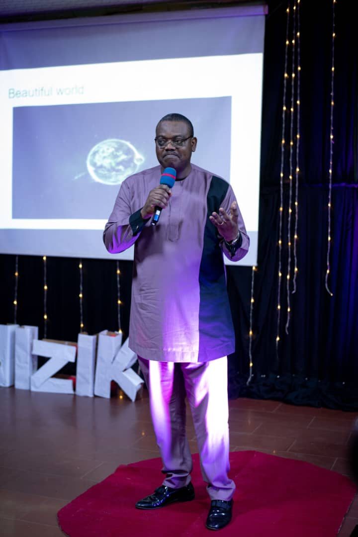 Amos Ologunleko speaking on stage